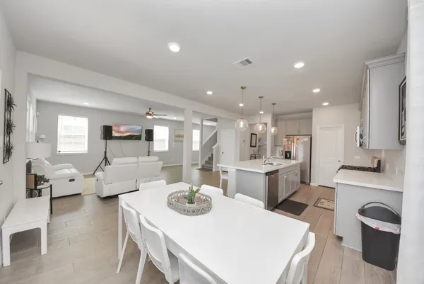 a large kitchen with a table and chairs