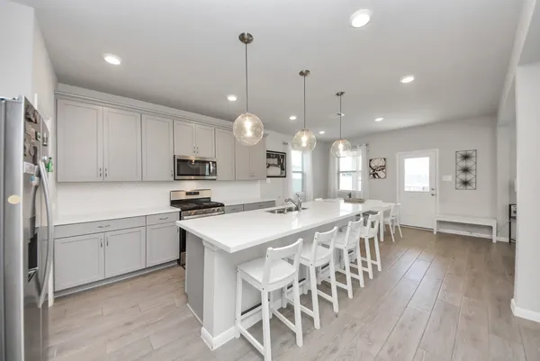 a kitchen with a sink a stove and refrigerator