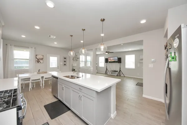 a kitchen with counter top space a sink stainless steel appliances and cabinets