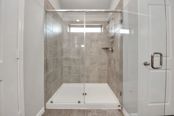 a bathroom with a shower sink and mirror