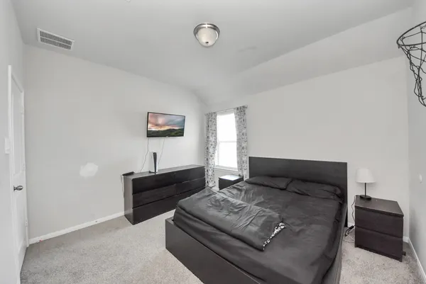 a bedroom with a bed and a desk