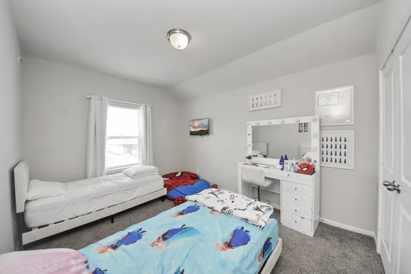 a bedroom with a bed and a table