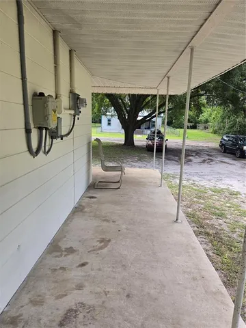 a view of a patio with table and chairs