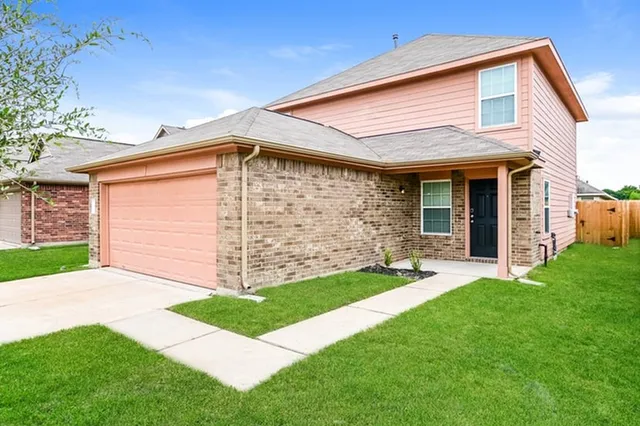 a front view of house with yard and lake view