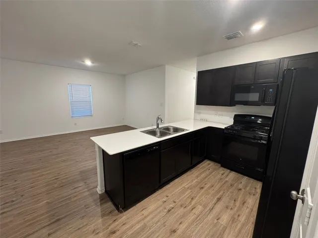 a kitchen with a sink and a stove top oven