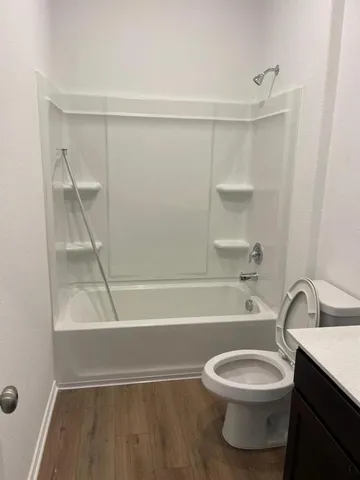 a bathroom with a toilet a sink and bathtub