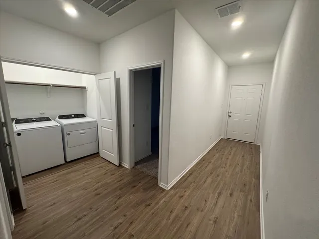 a view of a kitchen with a sink and wooden floor