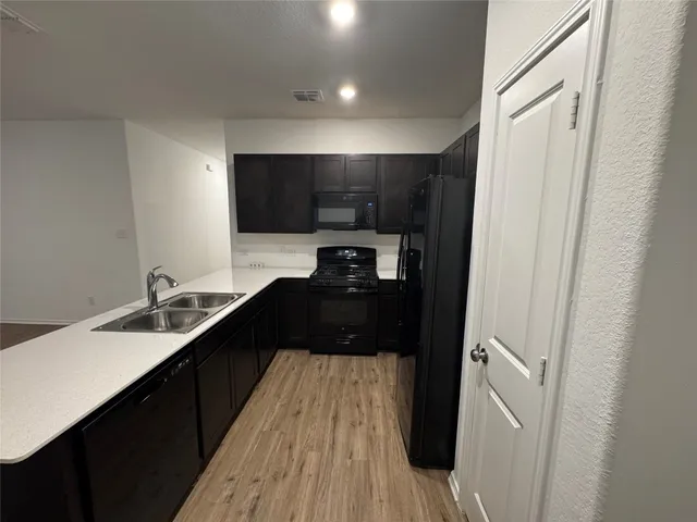 a kitchen with a sink and a refrigerator