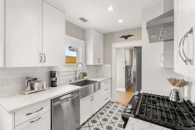 a kitchen with a sink stove and refrigerator