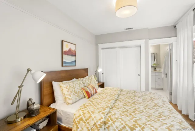 a bedroom with a bed and a window