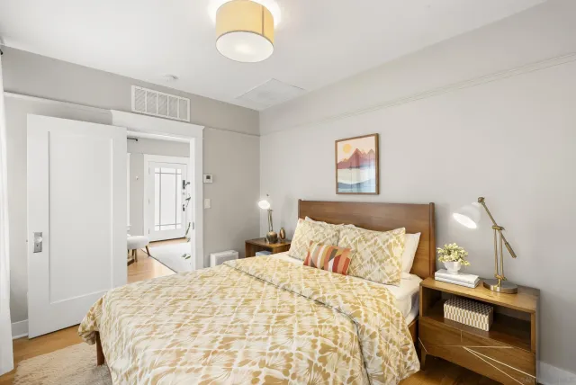 a bedroom with a bed and a lamp