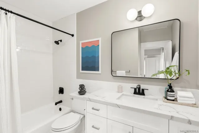 a bathroom with a sink and a mirror with toilet