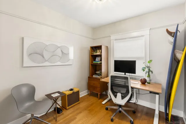 a view of a workspace with furniture and a flat screen tv
