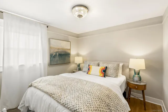 a bedroom with a bed and a lamp