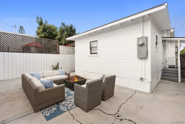 a view of a patio with couches and potted plants