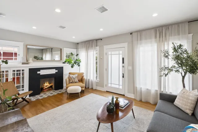 a living room with furniture and a fireplace