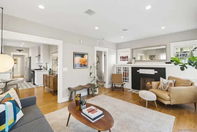 a living room with furniture and a fireplace