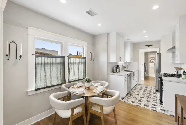 a kitchen with a dining table and chairs