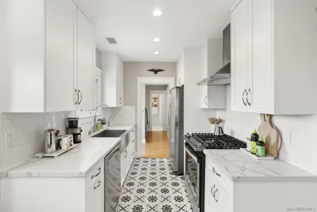 a kitchen that has a lot of cabinets in it and appliances