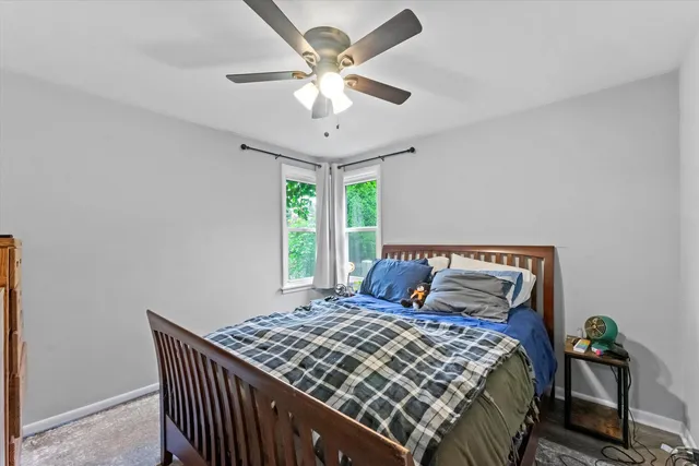 a bedroom with a large bed and a chandelier