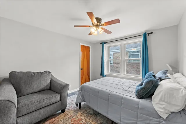 a bedroom with a bed couch and window
