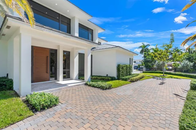 a front view of a house with garden and plants