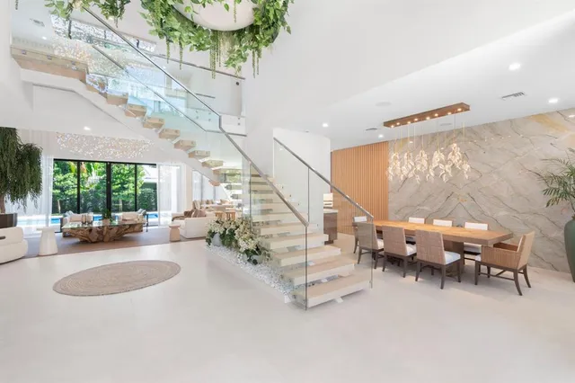 a large white kitchen with a large window and counter space