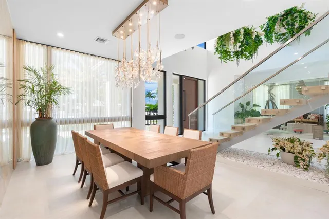 a living room with patio furniture and a potted plant