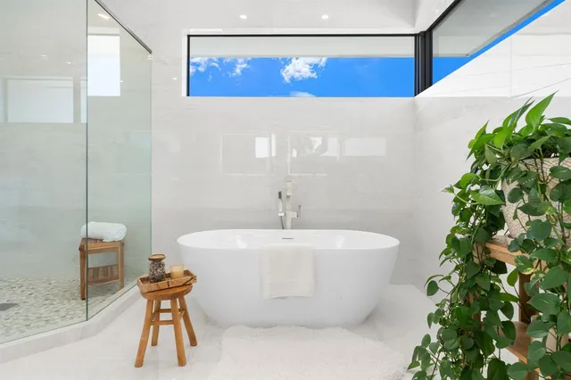 an aerial view of residential houses with outdoor space and trees