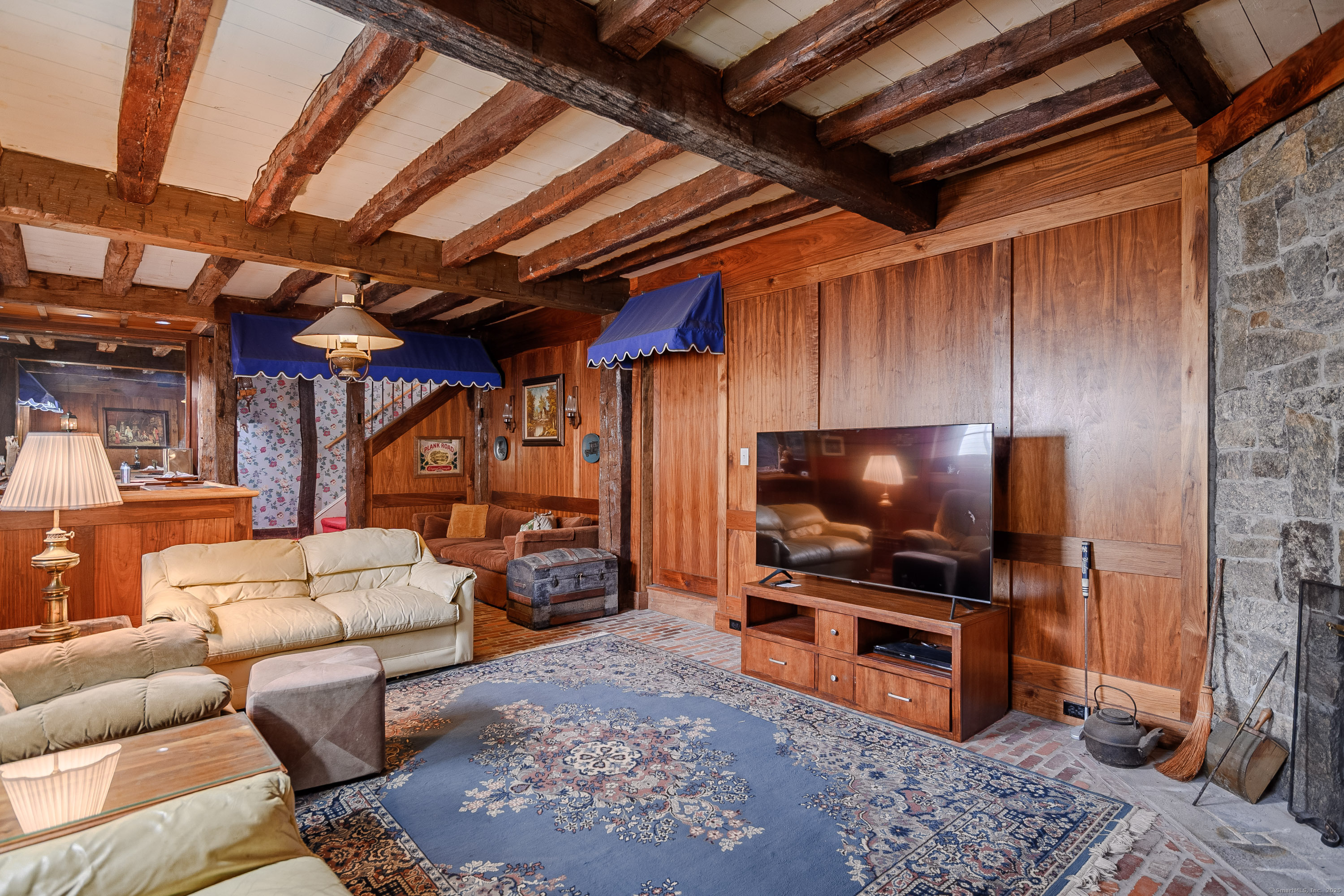 49 Great Ring Road Newtown, CT 06482 - Photo 26 of 40 The lower level den, filled with beautiful exposed wood, is the perfect escape to wind down