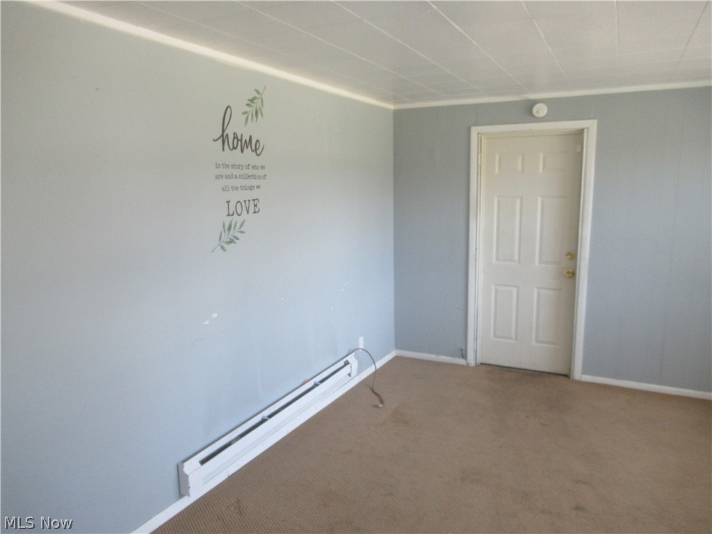 6033 Randy Road Bedford Heights, OH 44146 - Photo 4 of 19 Interior room featuring light blue walls, a white paneled door, and beige carpet