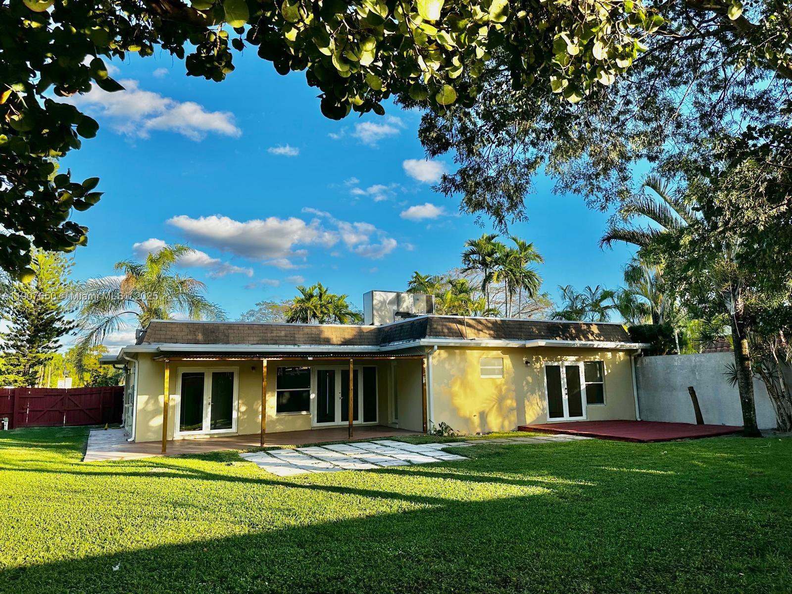 8420 Southwest 102nd Avenue, Unit 8420 Miami, FL 33173 - Photo 11 of 12 a front view of a house with a garden