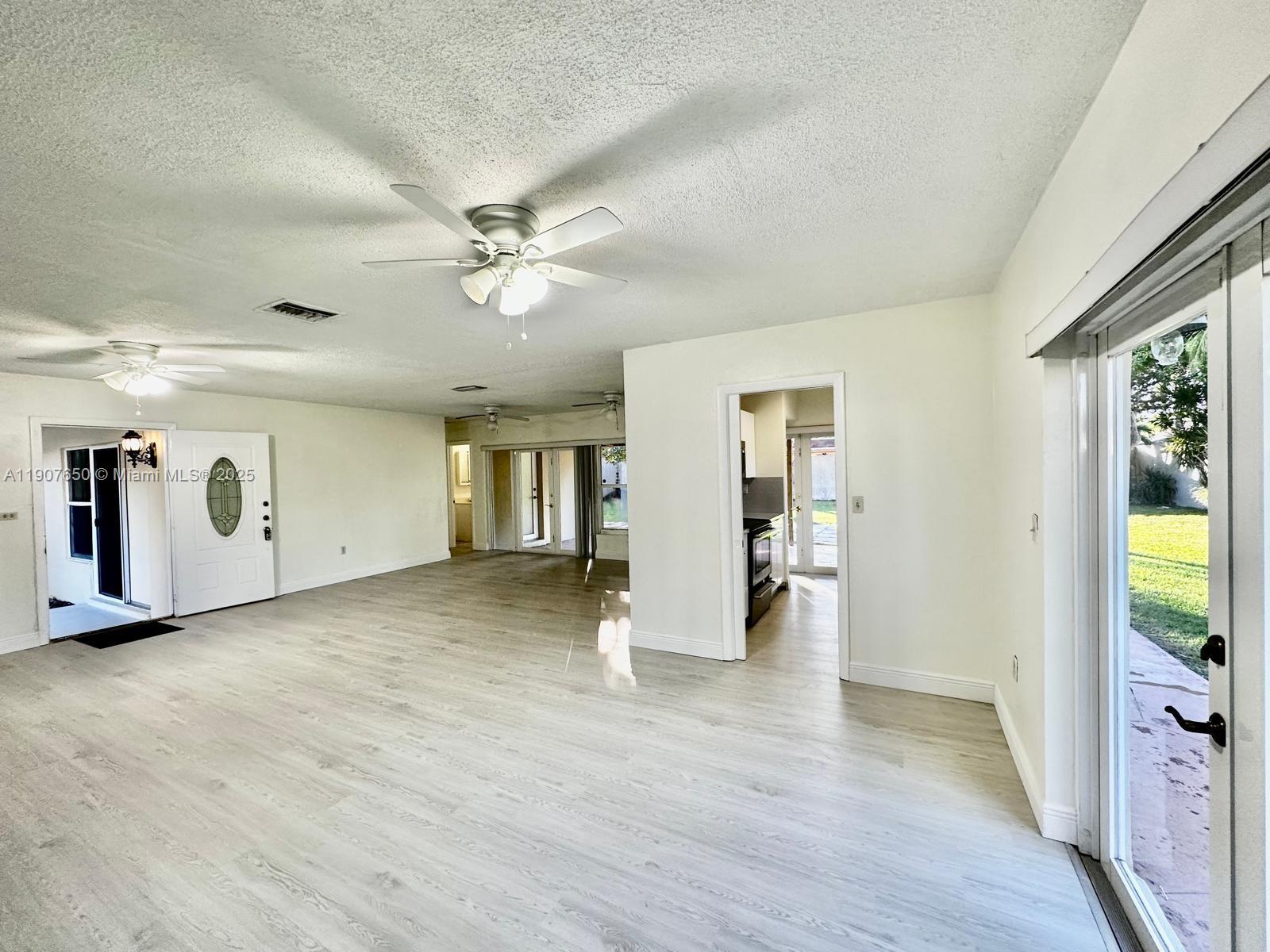 8420 Southwest 102nd Avenue, Unit 8420 Miami, FL 33173 - Photo 4 of 12 a view of an empty room with window and cabinet