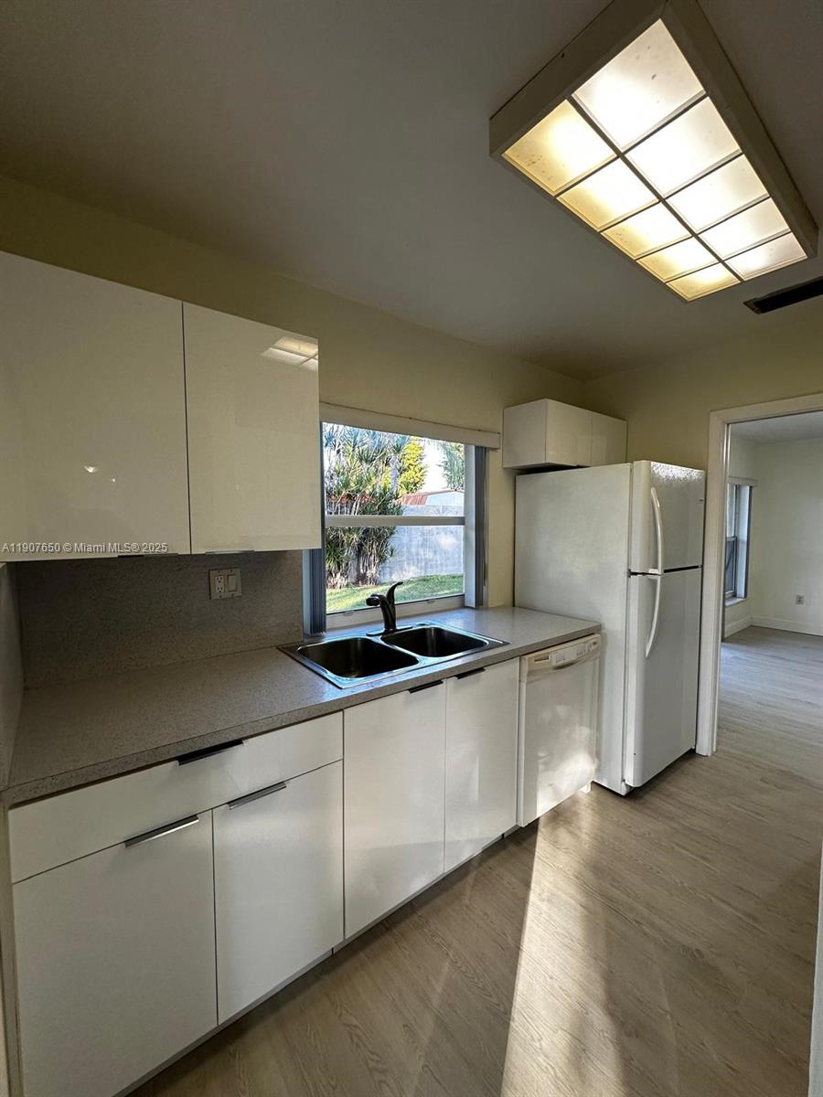 8420 Southwest 102nd Avenue, Unit 8420 Miami, FL 33173 - Photo 9 of 12 a kitchen with stainless steel appliances granite countertop a sink and a stove