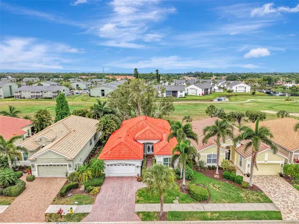 an aerial view of a house with outdoor space lake view and mountain view in back