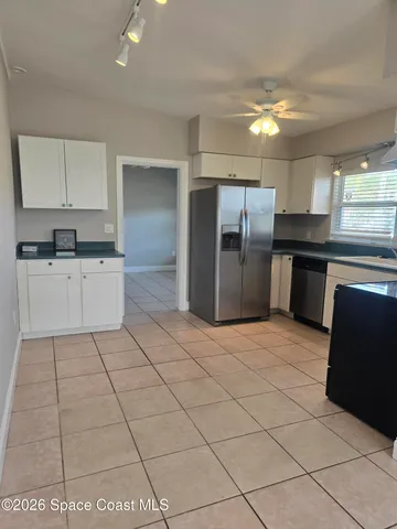 a kitchen with stainless steel appliances granite countertop a refrigerator and a stove