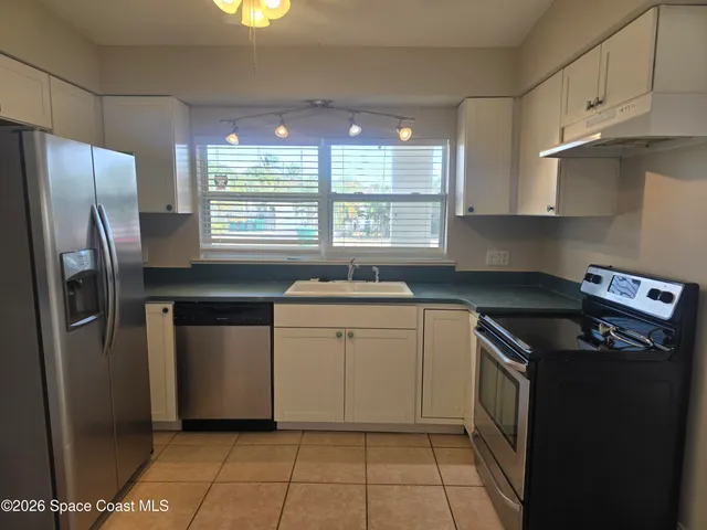 a kitchen with a sink stove and refrigerator