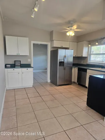 a kitchen with stainless steel appliances granite countertop a refrigerator and a stove