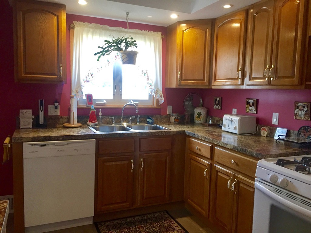 226 Winton Street Springfield, MA 01118 - Photo 5 of 27 a kitchen with stainless steel appliances granite countertop a sink stove and cabinets