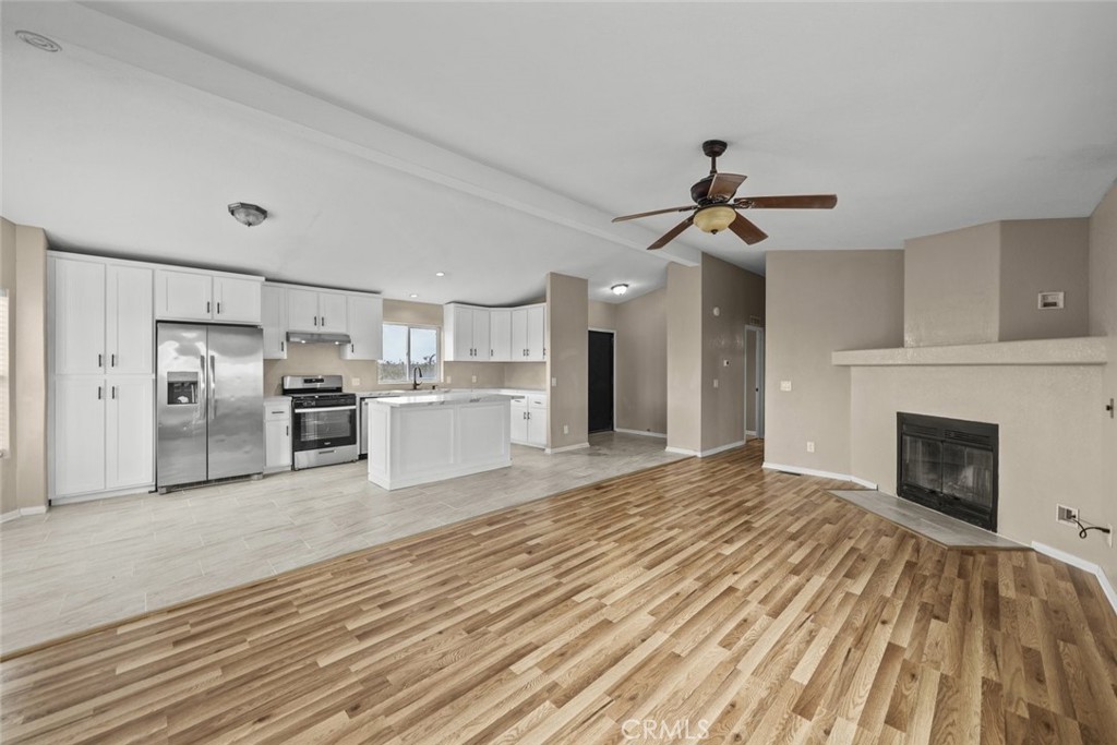 6142 Rare Rabbit Avenue Mojave, CA 93501 - Photo 14 of 50 a view of a kitchen with a stove cabinets and wooden floor