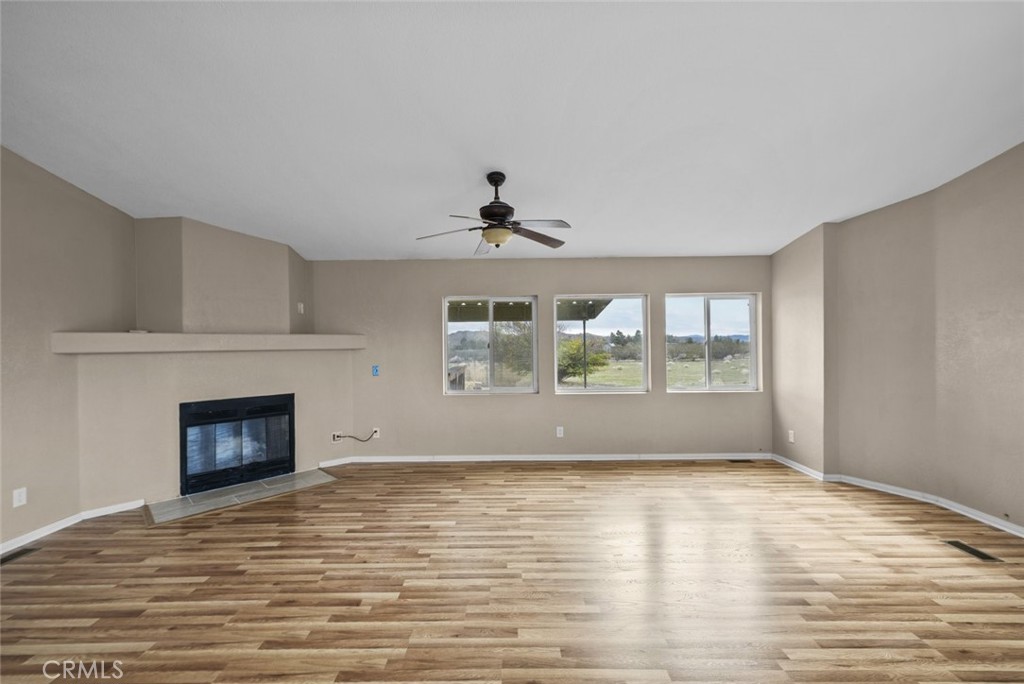 6142 Rare Rabbit Avenue Mojave, CA 93501 - Photo 15 of 50 a view of an empty room with wooden floor and a window