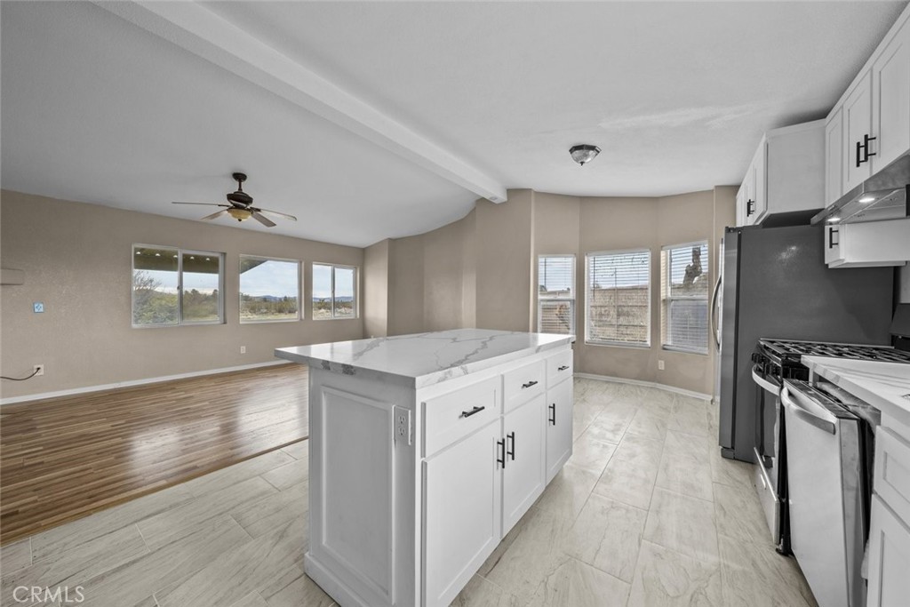 6142 Rare Rabbit Avenue Mojave, CA 93501 - Photo 18 of 50 a kitchen with granite countertop a stove and a sink