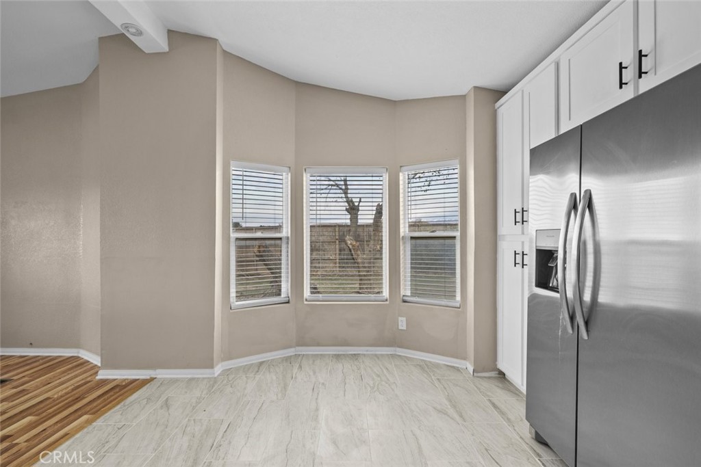 6142 Rare Rabbit Avenue Mojave, CA 93501 - Photo 19 of 50 an empty room with a fireplace and windows