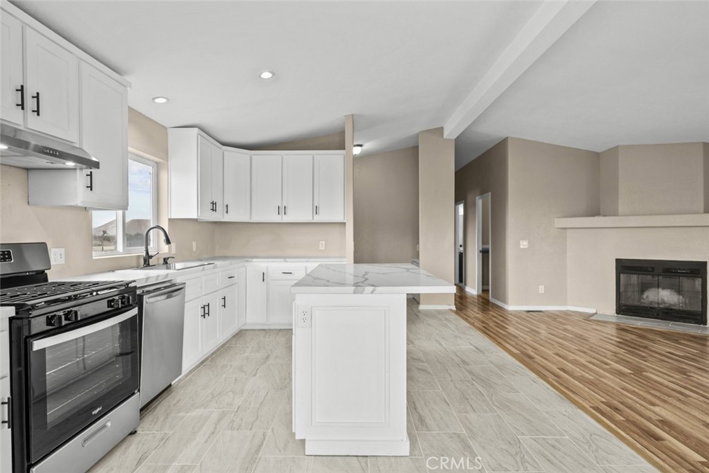 6142 Rare Rabbit Avenue Mojave, CA 93501 - Photo 21 of 50 a kitchen with stainless steel appliances granite countertop a stove top oven a sink and a refrigerator
