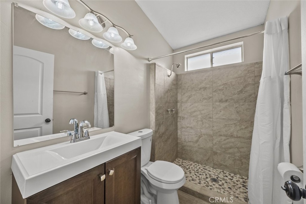6142 Rare Rabbit Avenue Mojave, CA 93501 - Photo 30 of 50 a bathroom with a sink a toilet and shower