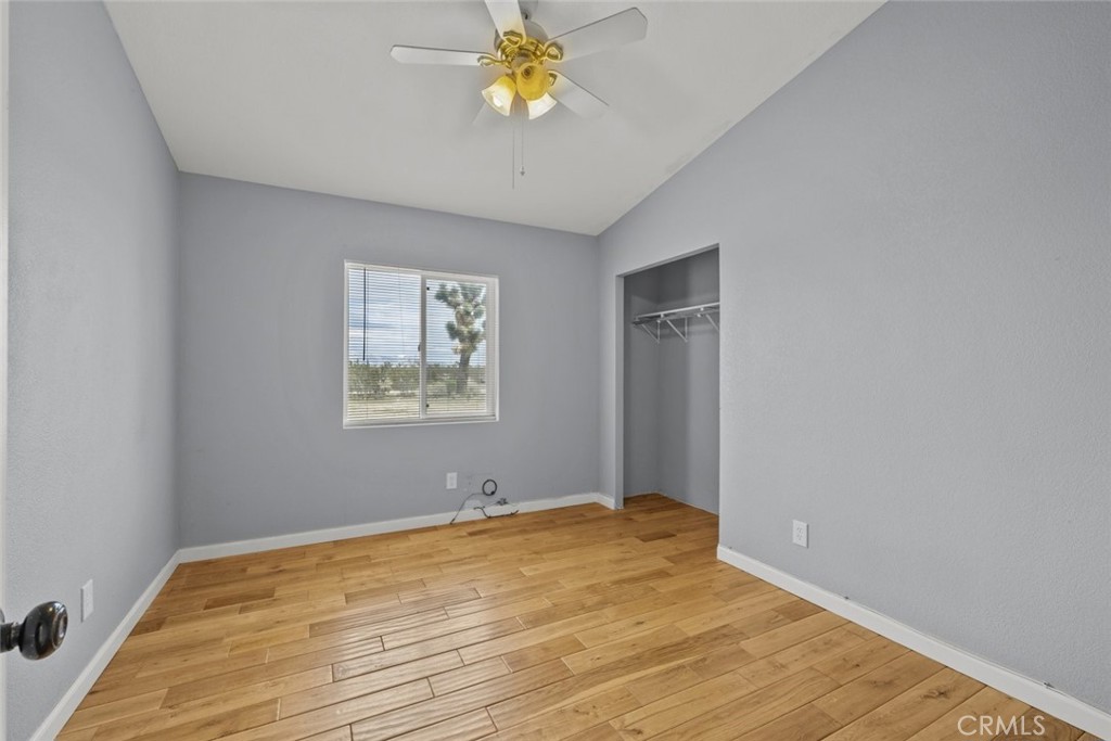 6142 Rare Rabbit Avenue Mojave, CA 93501 - Photo 31 of 50 a view of empty room with wooden floor and fan