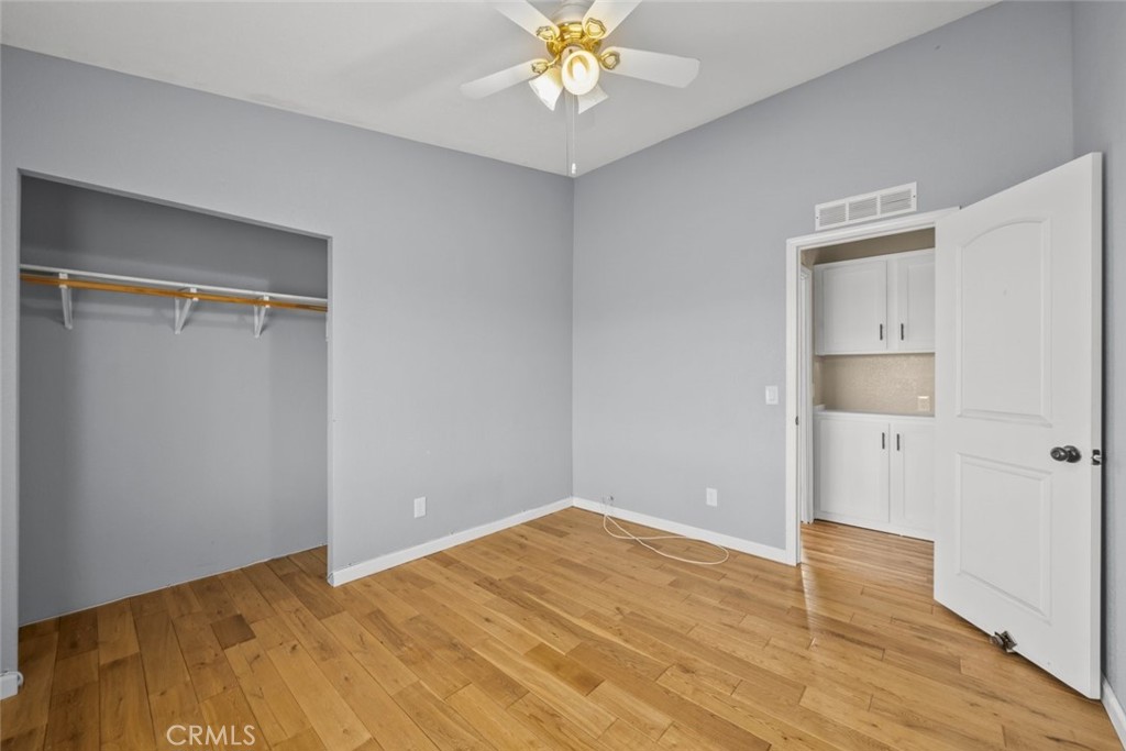 6142 Rare Rabbit Avenue Mojave, CA 93501 - Photo 32 of 50 a view of an empty room with window and wooden floor