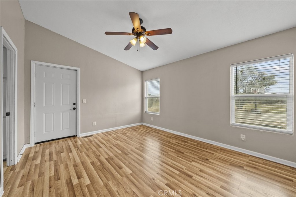 6142 Rare Rabbit Avenue Mojave, CA 93501 - Photo 33 of 50 a view of an empty room with wooden floor and a window