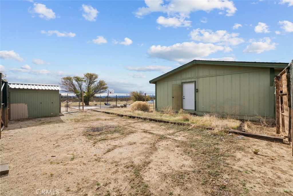 6142 Rare Rabbit Avenue Mojave, CA 93501 - Photo 39 of 50 a yellow house with a outdoor space