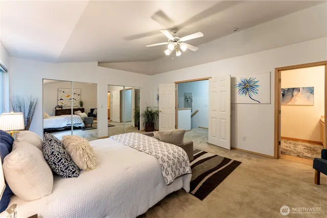 a bedroom with a large bed and a chandelier